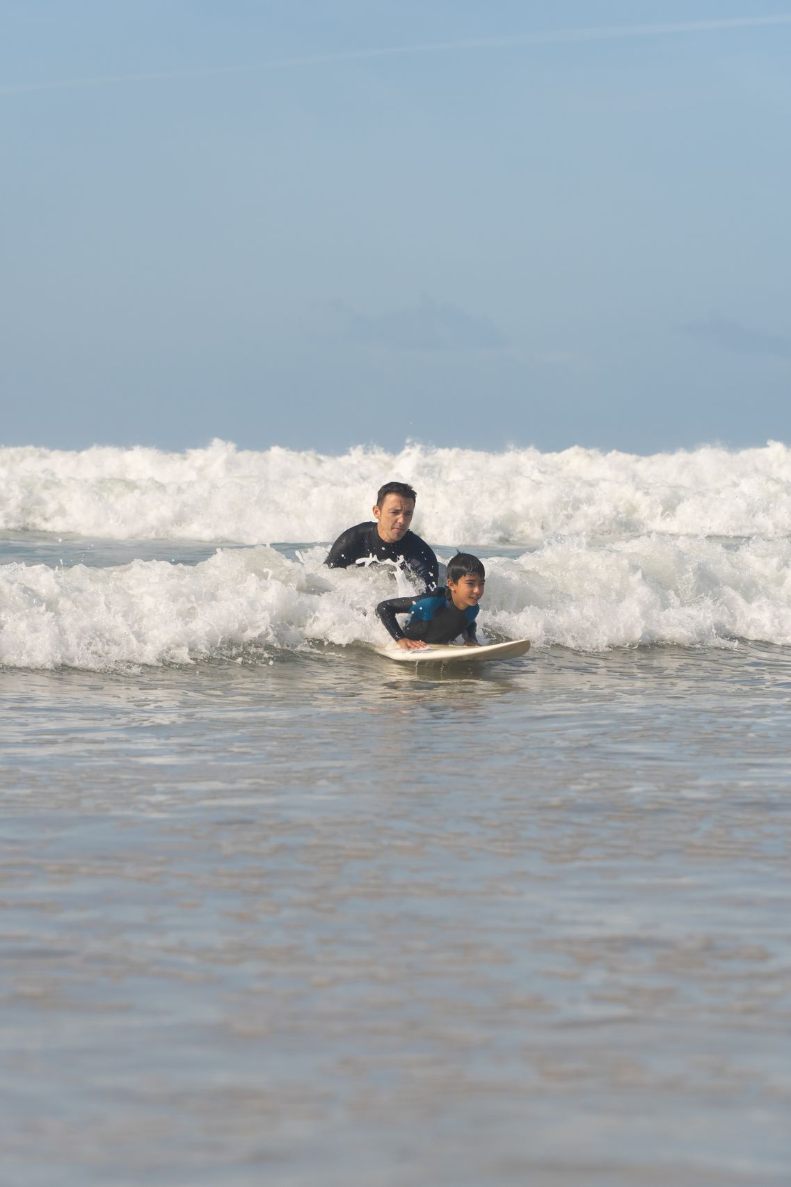 Surf instructor helping student